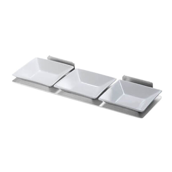 A Rosseto stainless steel spice shelf with three white square porcelain dishes.