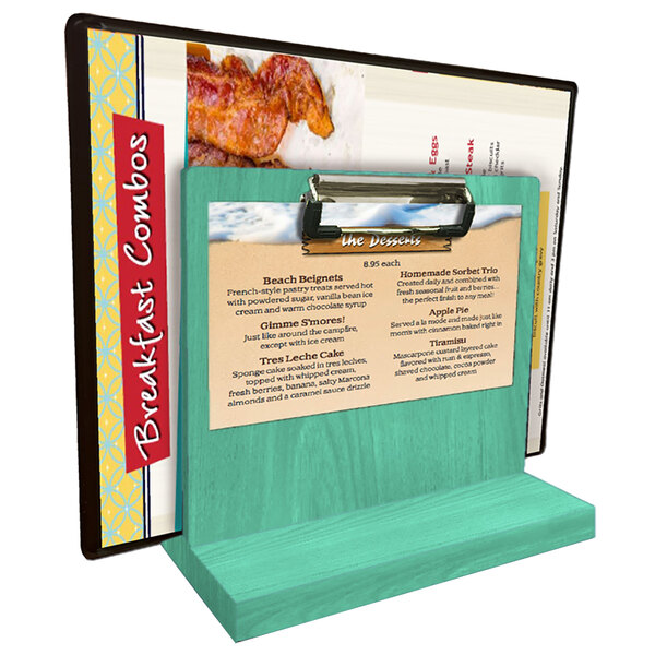 A Menu Solutions washed teal wood tabletop menu caddy with clip holding a menu.