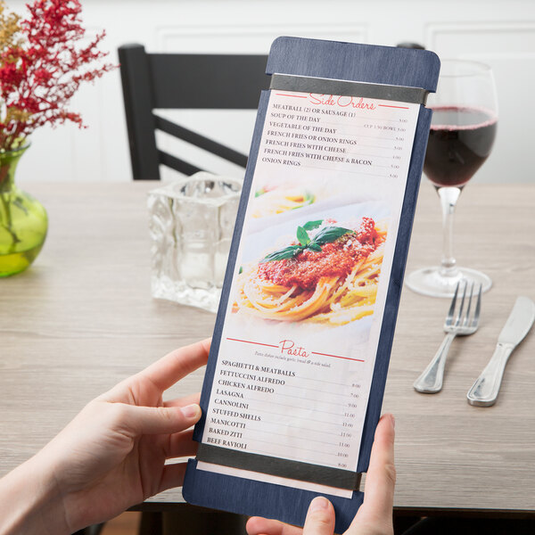 A person holding a Menu Solutions customizable wood menu board with rubber band straps.