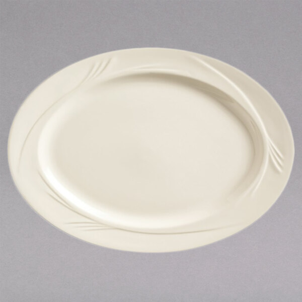 A white Libbey medium rim china platter with a curved edge.