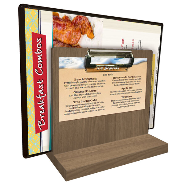 A Menu Solutions weathered walnut wood tabletop menu caddy with a menu on it.