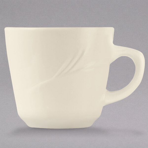 A Libbey cream white china tall cup with a handle.