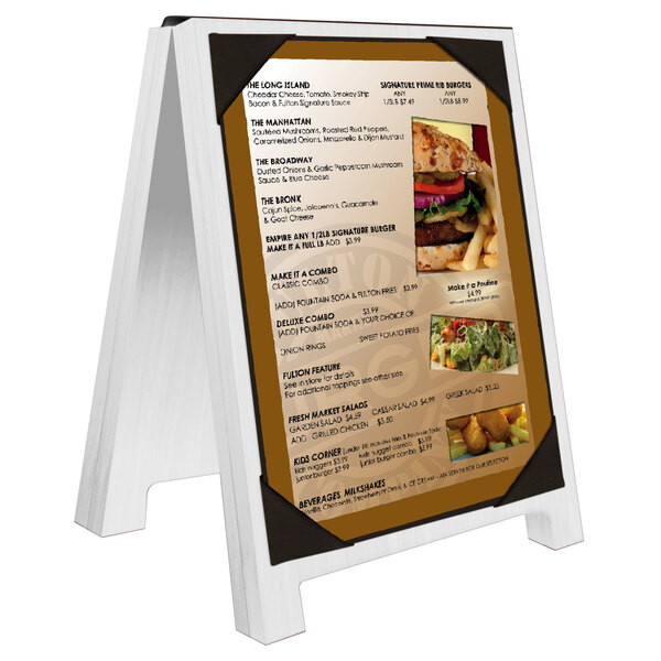 A white Menu Solutions wood sandwich menu board with picture corners on a table.