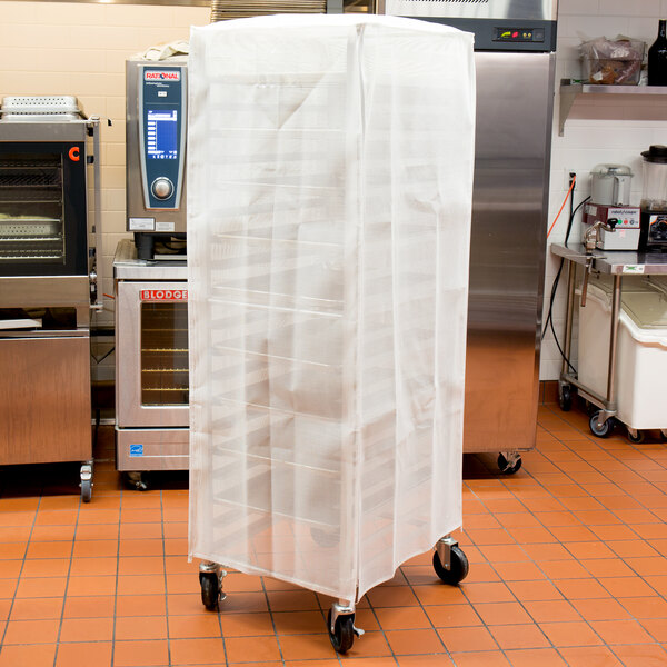 A white plastic Curtron bun pan rack cover on a rack in a kitchen.