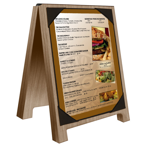 A Menu Solutions weathered walnut wood sandwich menu board with black picture corners on a white background.