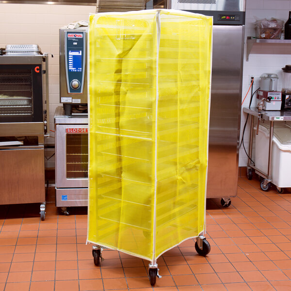 A yellow Curtron Supro breathable mesh sheet pan rack cover on a bun pan rack.