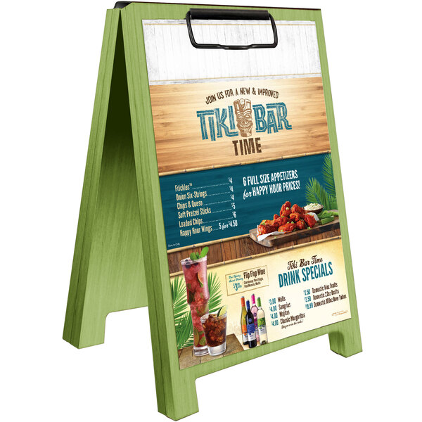 A Menu Solutions lime wood sandwich menu board tent with clip on a table in a cocktail bar.