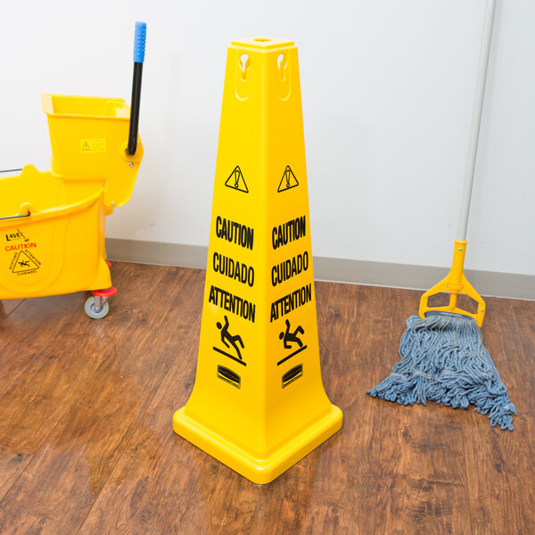 Rubbermaid FG627600YEL 36" Yellow Multi-Lingual Wet Floor Cone-Shaped Sign - "Caution"