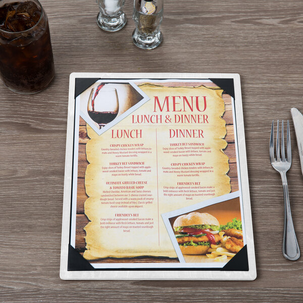 A customizable wood menu board with picture corners on a table with a menu showing pictures of food and drinks.