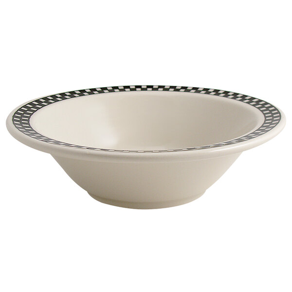 A creamy white china bowl with black and white checkered trim.