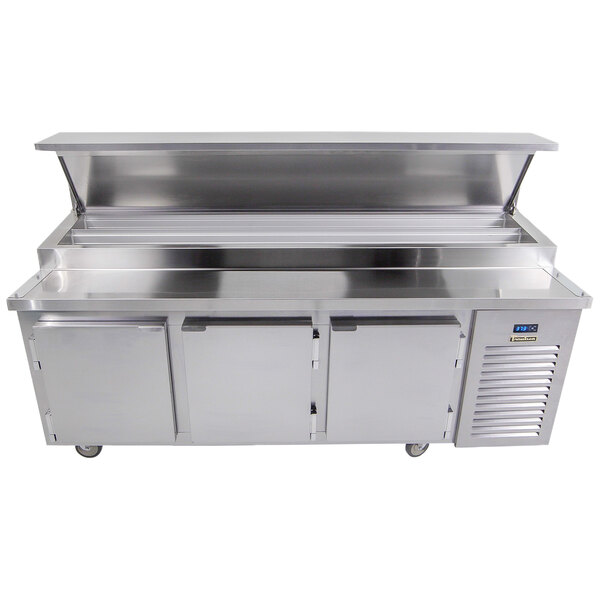 A Traulsen stainless steel refrigerated pizza prep table with 3 doors and 2 pan rails.