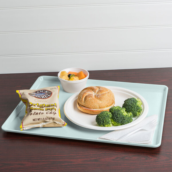 A Cambro dietary tray with a sandwich, broccoli, and a bagel on it.