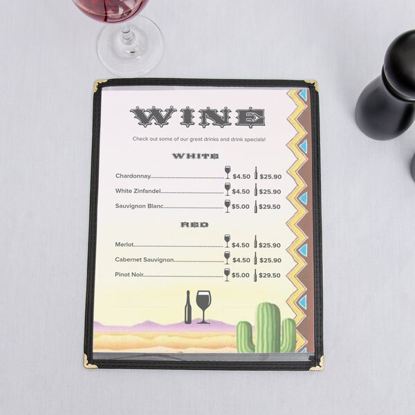 A menu with a cactus design on a table with wine glasses.