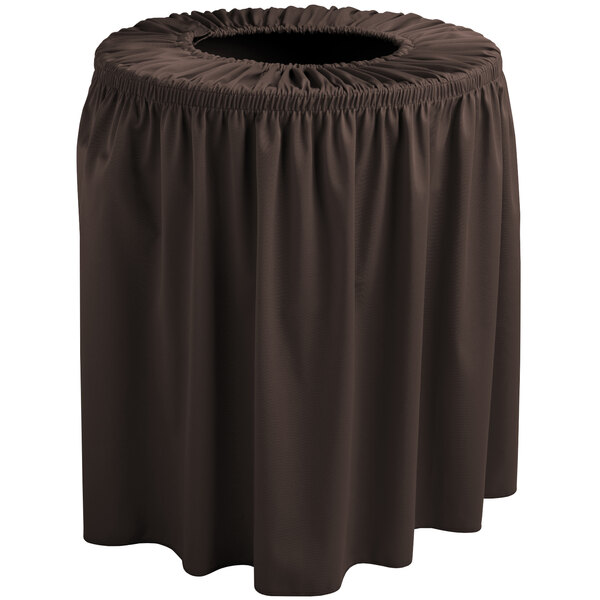 A brown Snap Drape Wyndham shirred pleat trash can cover on a table with a brown tablecloth.