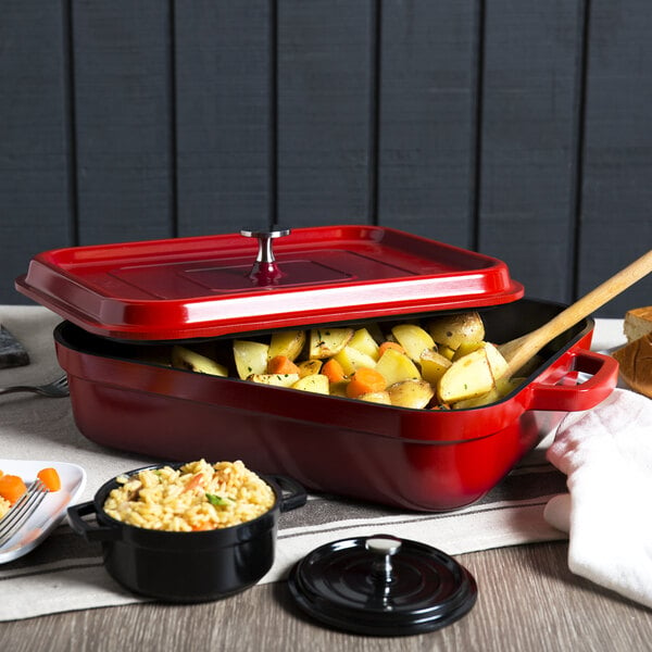 A red roasting pan with food in it.