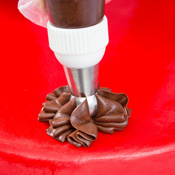 A person using an Ateco Russian ball tip piping tip with a pastry bag to make chocolate.