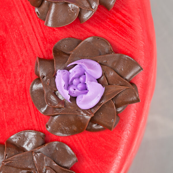 A chocolate flower with purple frosting made using an Ateco Russian piping tip.
