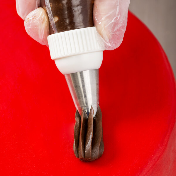 A person using an Ateco swirl top piping tip on a pastry bag.
