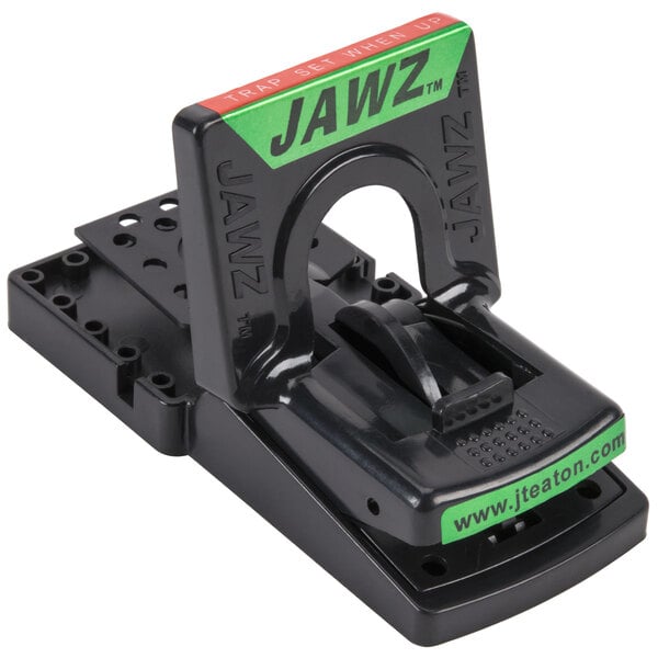 A black JT Eaton Jawz mouse trap on a table with a green label.