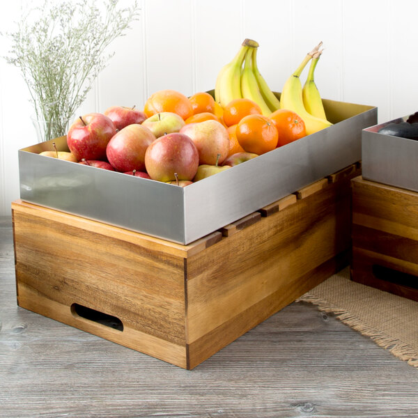 A Tablecraft stainless steel rectangular bowl on a table full of fruit.