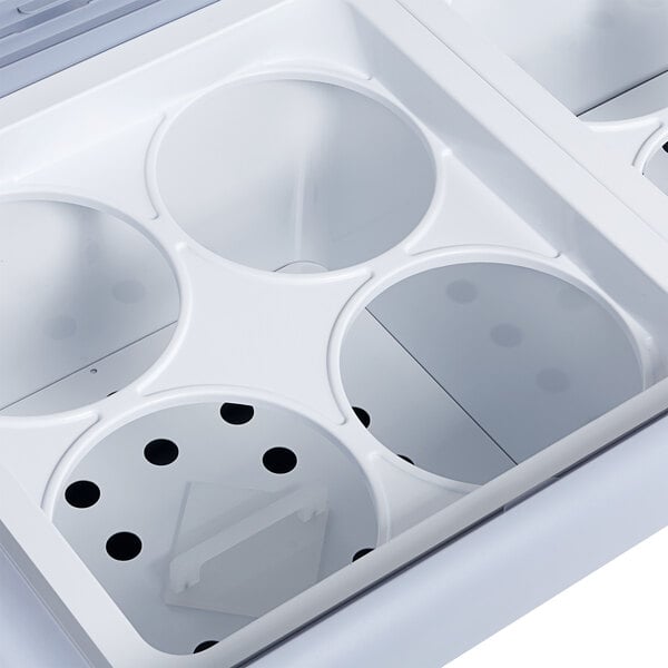 An Avantco white ice cream dipping cabinet with curved sneeze guard and two holes.