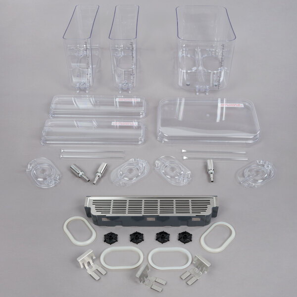 A group of clear plastic parts including a bowl, lid, and handle.
