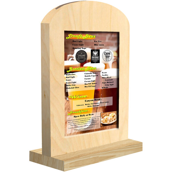 A natural arched wood menu tent with a menu on a table.