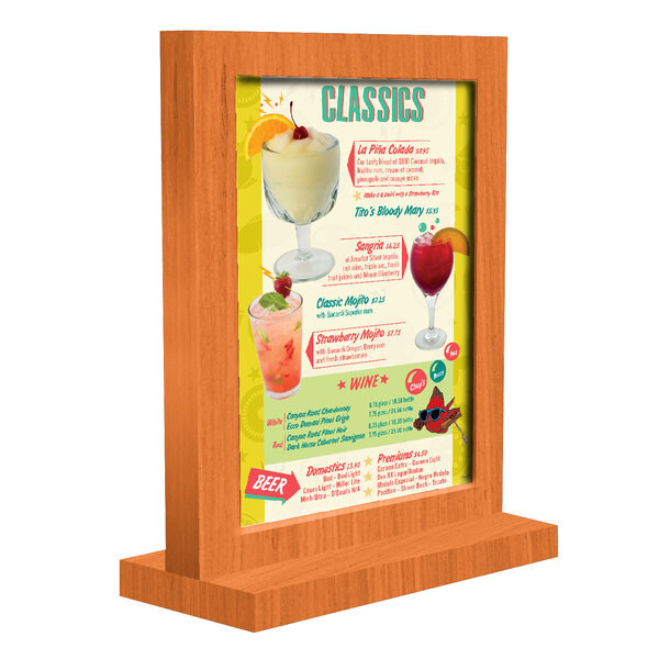A Menu Solutions framed wood menu tent on a table with drinks.
