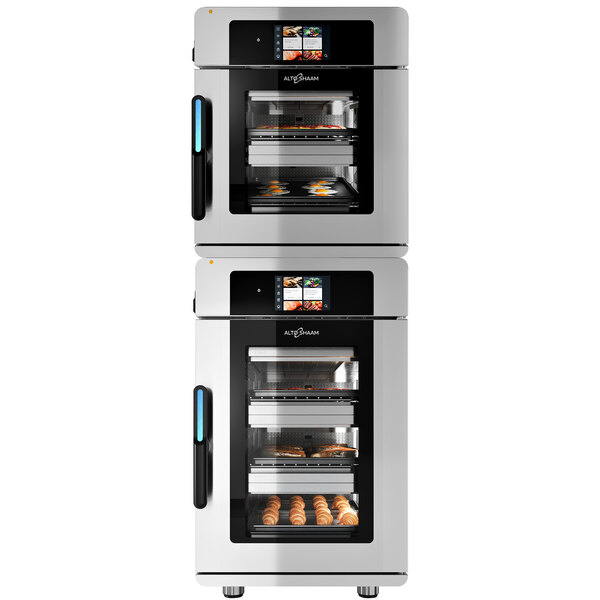 A room with two large Alto-Shaam Vector multi-cook ovens with different types of food inside.