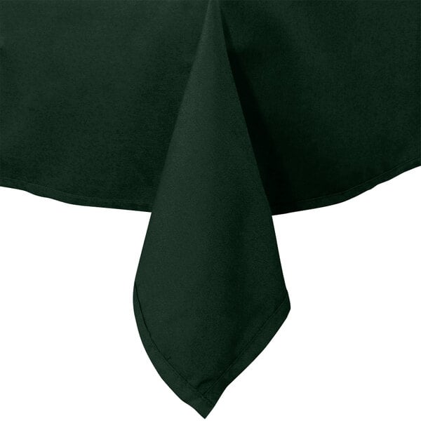 A folded hunter green Intedge table cloth on a table.