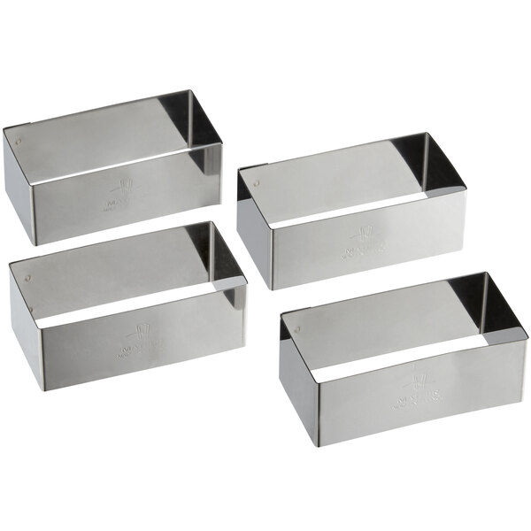 A group of four silver rectangular Matfer Bourgeat stainless steel rectangle cake rings.