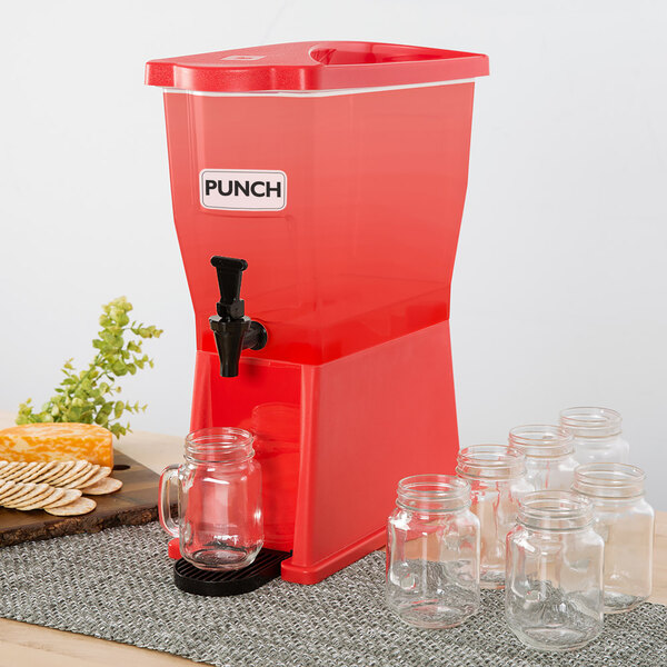 A red machine with Choice beverage dispenser labels on glass jars on a table.