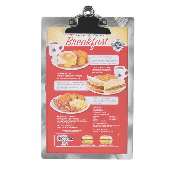 A Menu Solutions Alumitique clipboard with a breakfast menu on it.