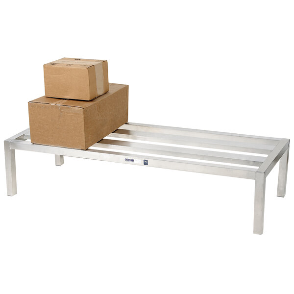 A Channel aluminum dunnage rack with boxes on it.