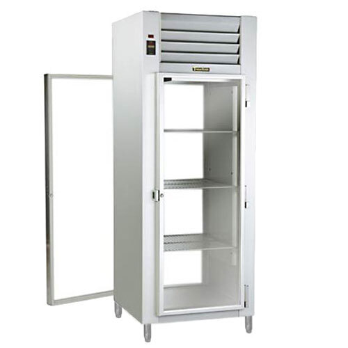 A white metal Traulsen specification line holding cabinet with glass doors and shelves.