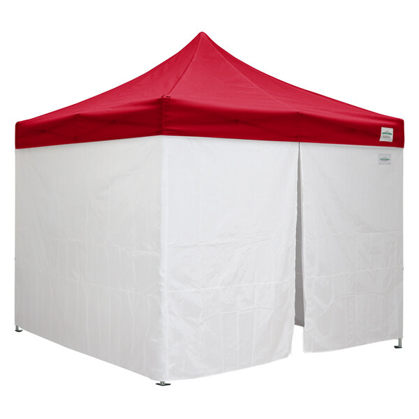 A white tent with a red top.