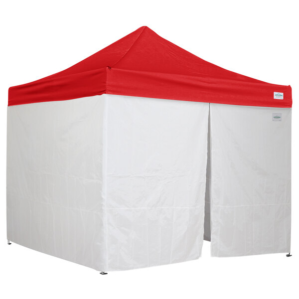 A white tent with a red top.