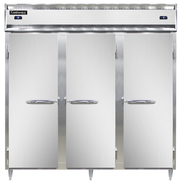 A group of three Continental stainless steel refrigerators with open doors.