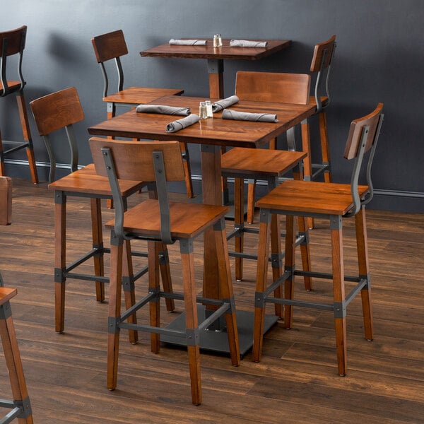 A Lancaster Table & Seating wooden table and chair set in a restaurant dining area.