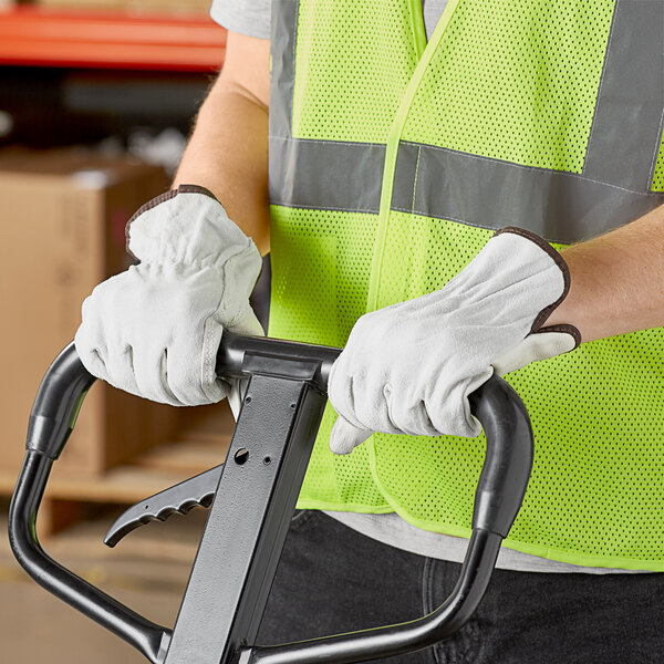 A person wearing Cordova Select Grain Cowhide Leather Driver's Gloves and a safety vest.