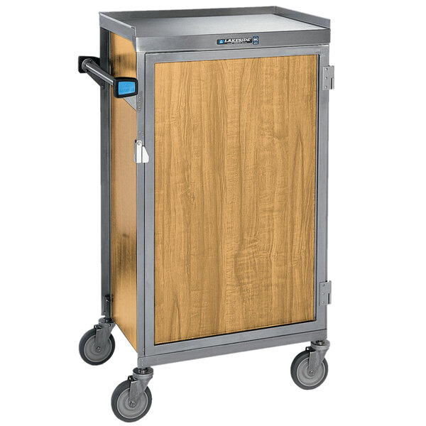 A Lakeside stainless steel meal delivery cart with light maple finish and a wooden door.