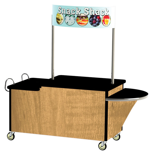A Lakeside stainless steel vending cart with light maple accents and a sign on top that says "snack"