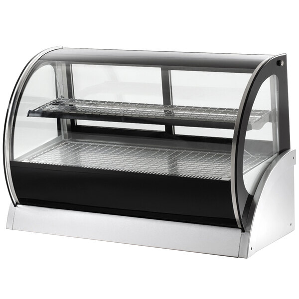 A Vollrath curved glass countertop display refrigerator on a bakery counter.