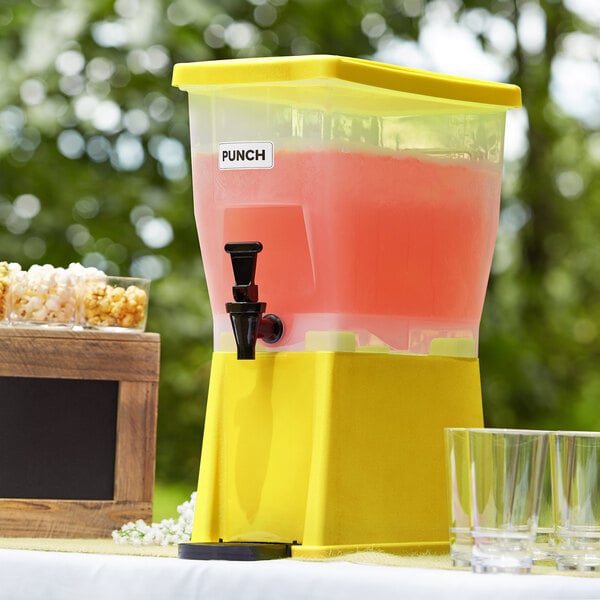 A yellow and pink Choice 3 Gallon beverage dispenser with a black spigot and glasses.