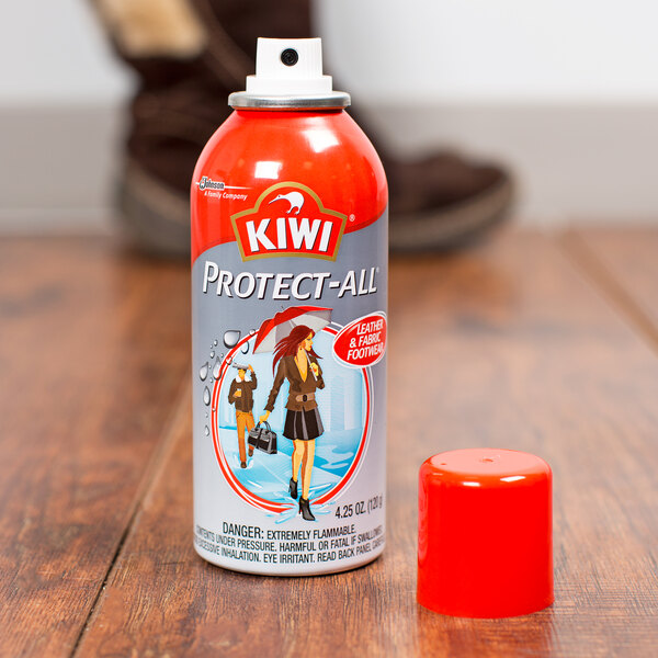 A can of SC Johnson Kiwi Rain and Stain Protect All spray on a wood surface.