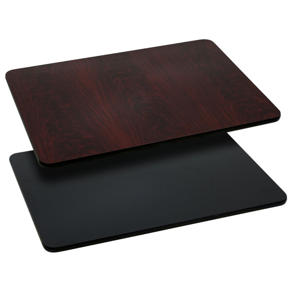 A close-up of a black and mahogany Flash Furniture rectangular table top.