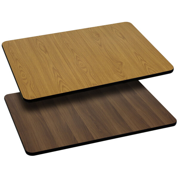 A Flash Furniture rectangular table top with natural and walnut wood grain on a table.