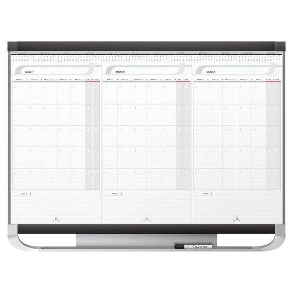 A white Quartet Total Erase 3-month calendar on a whiteboard.
