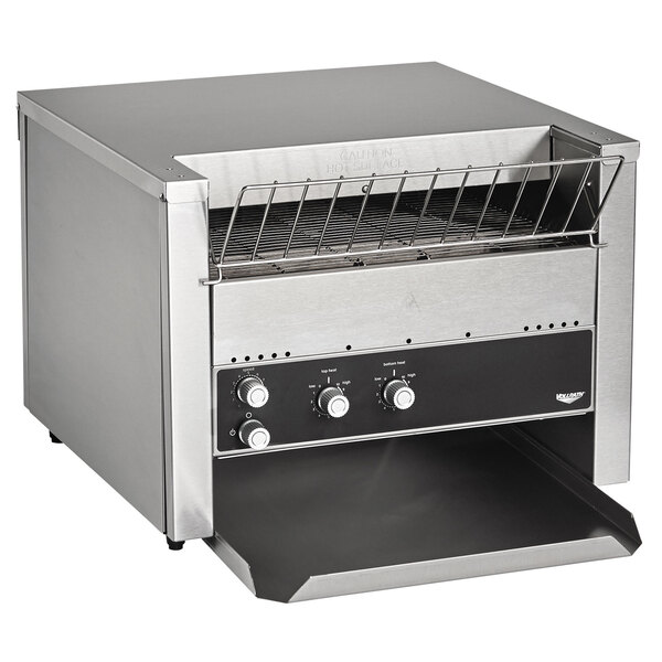A Vollrath JT3 conveyor toaster on a counter in a professional kitchen.