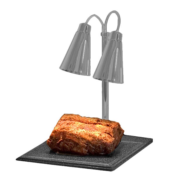 A piece of meat on a square plate with two Hanson Heat Lamps over it.